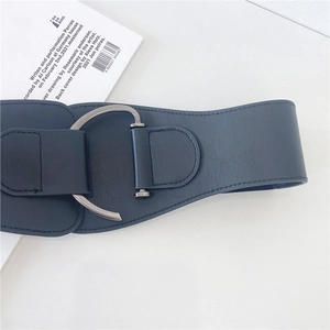 Deep blue wide waist belt for women with a large silver C-shaped metal buckle on white background