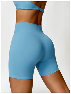 Detail of high-waisted light blue yoga shorts with V-shaped seam for booty lifting effect