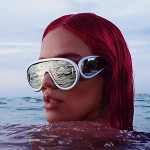 Futuristic large-frame silver sunglasses with integrated reflective lenses on model