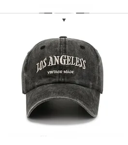 Detail of Los Angeles embroidery on vintage washed grey cotton baseball cap