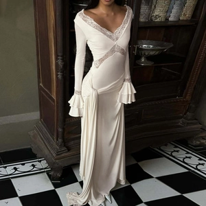 Detail of white V-neck lace dress featuring elegant ruffled sleeves and retro vintage style