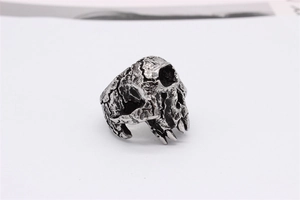 Macro view of vintage skull ring showing detailed rock texture and oxidized steel finish
