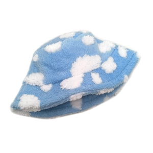 Close-up of soft blue plush bucket hat featuring a white cloud pattern and fuzzy texture