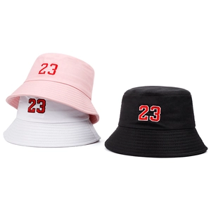 Detail view of cotton bucket hats in pink white and black with 23 embroidery