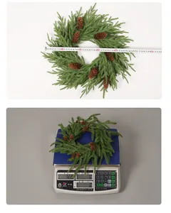 Measurement of 50cm Christmas pine needle wreath weight and diameter on a scale