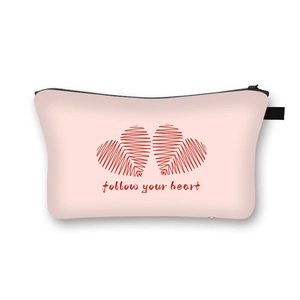 Pink heart patterned Valentine's makeup bag with follow your heart text and black zipper