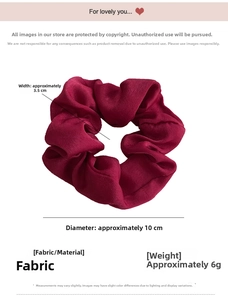 Detailed view of deep red satin scrunchie showing 10cm diameter and fabric texture