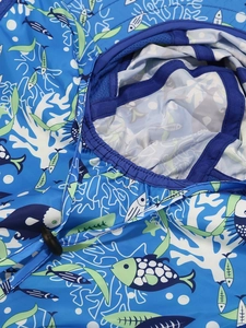 Macro detail of blue kids sun hat featuring breathable mesh lining and sea life patterns