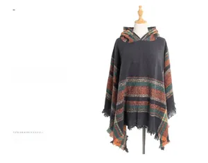 Detail of bohemian hooded shawl with orange and green stripes and long fringed tassels