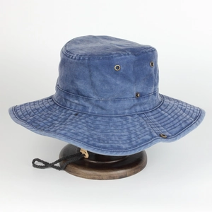 Detailed close-up of a blue washed cotton sun hat with metal vents and adjustable cord