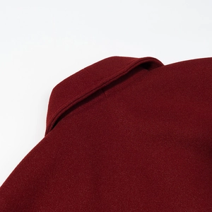 Detail view of the deep red wool coat collar showing high-quality stitching and texture