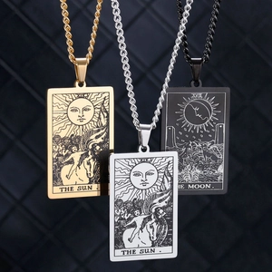 Detailed close-up of tarot card pendants in gold, silver, and black with sun moon designs