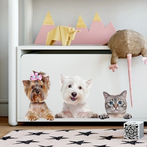 Detail of cute cat and dog wall decals applied on a white cabinet in a kids room