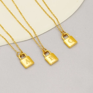 Three gold initial lock necklaces with engraved letters A, B, and C on delicate O-chains