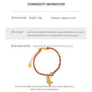 Detailed view of red woven bracelet with zircon cross pendant and extension chain