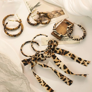 Exaggerated leopard print hoop earrings with bow ribbon and tassel for a trendy look