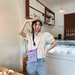 Mini purple Oxford cloth crossbody bag with carousel embroidery and rope strap on model