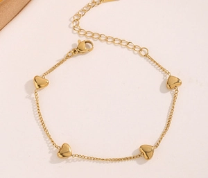 Detailed view of gold heart charm necklace with lobster clasp and adjustable extension chain