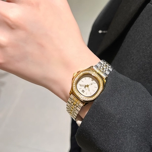 Elegant ladies quartz watch with diamond bezel and two-tone steel bracelet on wrist