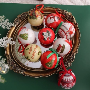 Christmas ball ornament set with reindeer and snowman designs on a gold mirror tray