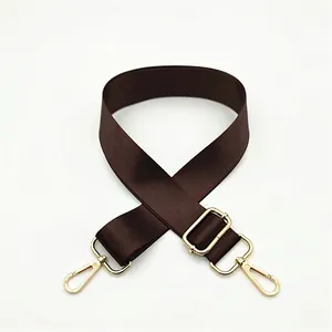 Detail of adjustable dark brown nylon strap with premium gold metal swivel hooks