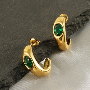 French vintage C-shaped gold earrings with inlaid green zircon from a 45-degree angle