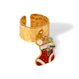 Macro detail of Christmas stocking pendant with rhinestones on golden hammered ring