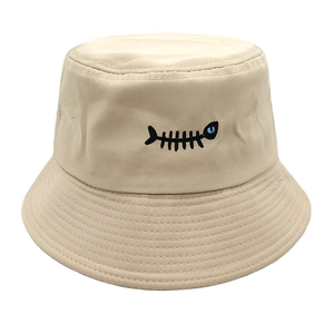 Detail of beige bucket hat with black fishbone embroidery and parallel stitched brim