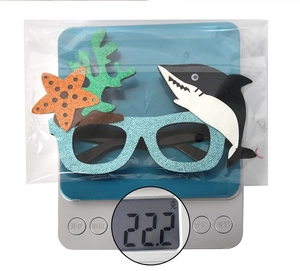 Detailed view of ocean party glasses with shark and starfish decor on a digital scale