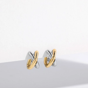 Detail view of bicolor gold and silver crisscross hoop earrings on minimalist card