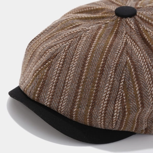 Detail of herringbone tweed pattern and black brim on a vintage newsboy cap for men