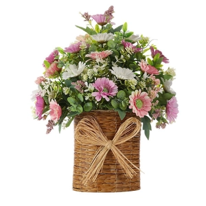 Pastel daisy and eucalyptus artificial plant in a woven basket with bow decoration