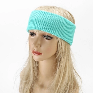 Mint green knitted headband with ribbed texture worn by a model for yoga and skincare