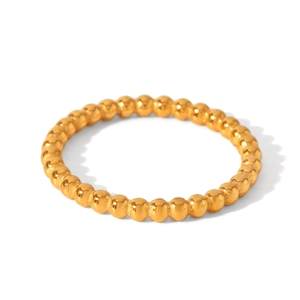 Macro view of gold-plated beaded stackable ring band with continuous round beads