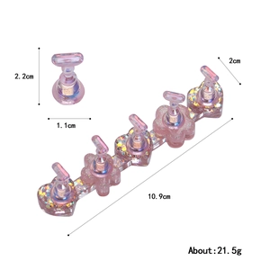 Pink aurora resin nail art display stands with heart and floral shapes on white background