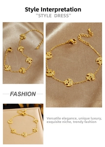 Detail view of gold-plated stainless steel bracelet with star and moon charms and crystals