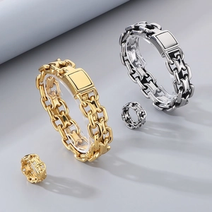 Detailed view of interlocking gold and silver chain bracelets with matching rings set