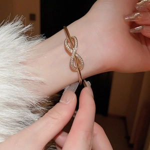 Elegant gold-plated infinity open cuff bracelet with sparkling zircon stones for women