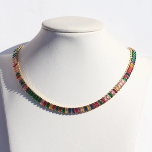 Detail of rainbow baguette-cut zircon necklace with gold-plated claw setting links