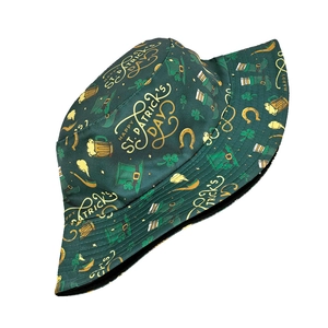 Detail of St. Patrick's Day patterns on green bucket hat with shamrocks and gold text