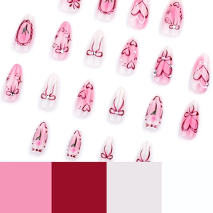 Pink and white almond press-on nails with sweet heart patterns and bow decorations