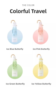 Detail of colorful butterfly umbrellas with elegant gold curved handles in four shades