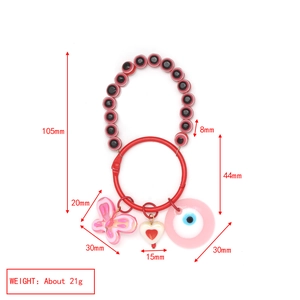 Detail view of evil eye keychain with heart and butterfly charms showing size measurements