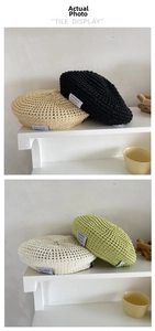 Close-up of crochet beret showing breathable mesh knit and minimalist fabric logo patches