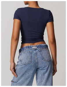 Rear view of slim fit dark blue yoga t-shirt with cropped waist and matte finish texture