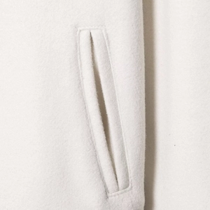 White wool baseball jacket with pocket details and minimalist crewneck design