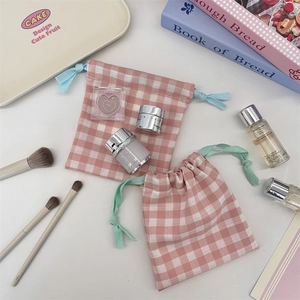 Detailed view of pink plaid drawstring bags for cosmetics with colorful ropes