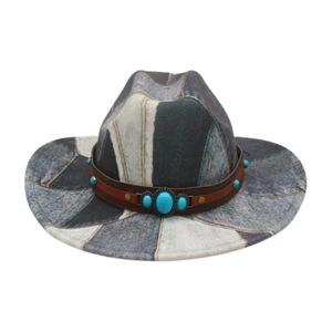 Detail of western cowboy hat featuring patchwork pattern and turquoise leather band