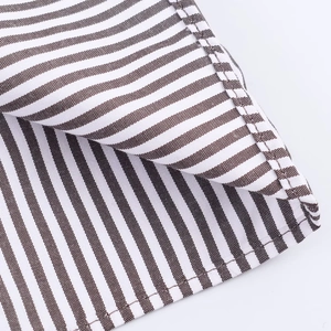 Macro shot of striped fabric detailing brown and white diagonal twill shirt texture