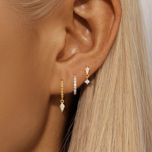 Close-up of gold plated S925 silver earring set with sparkling marquise and square zircons